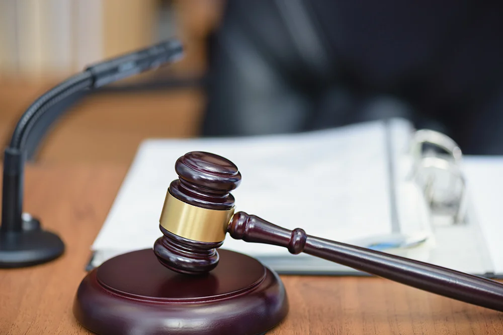 Court hearing.Court, courtroom, wooden hammer. Wooden table, books, microphone on the table of the judge.