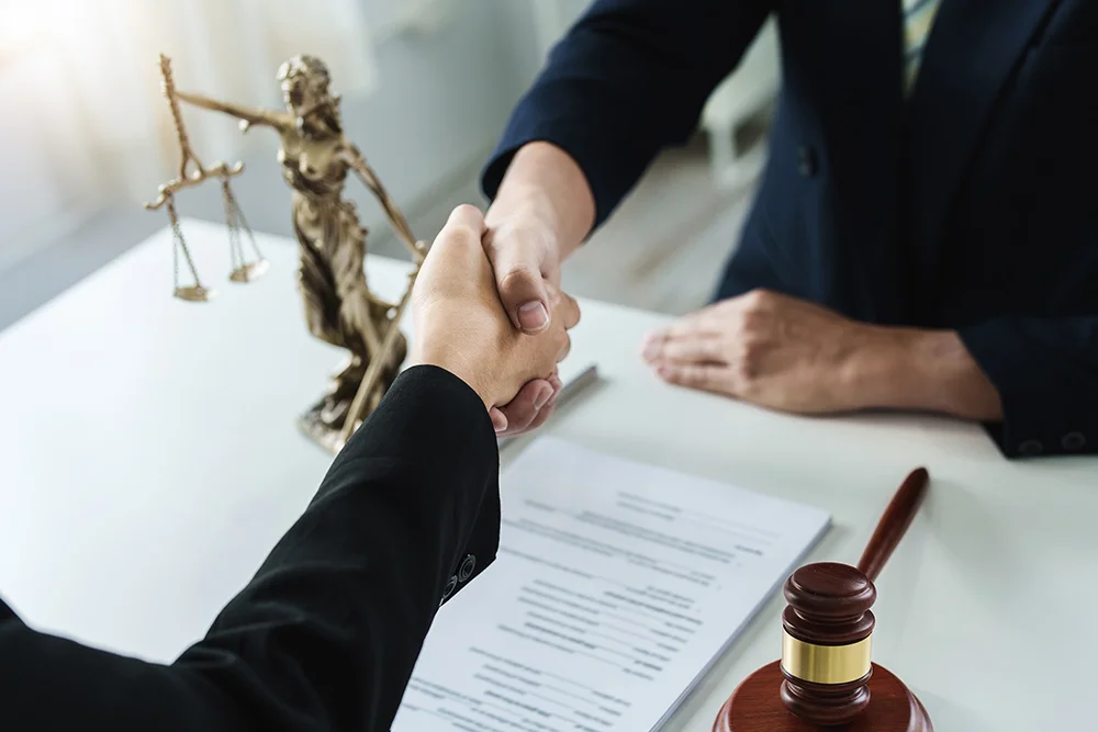 Law, consultation, agreement, contract, lawyer or attorney shakes hands to agree on the client's offer to be hired to fight the parties in court