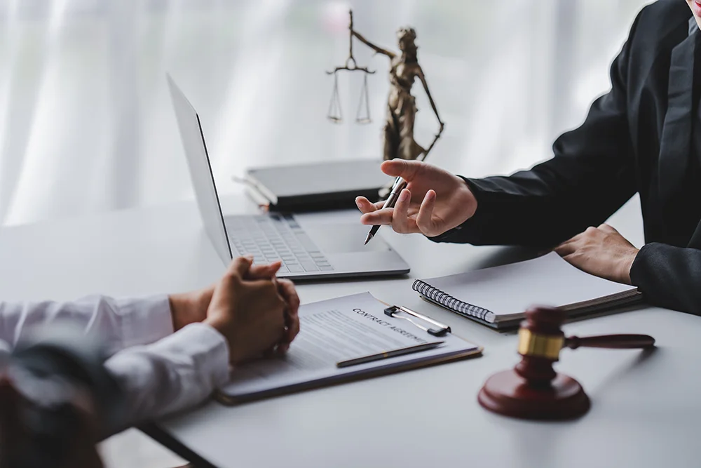 concept of justice and law A male judge in the courtroom on a wooden table and a male counselor or lawyer working in the office. Law, advice and justice concepts.