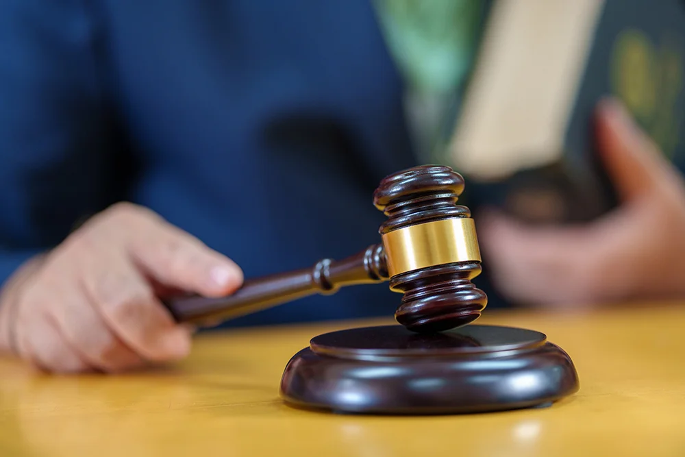 close up male Judge hitting Gavel off a block in courtroom, law and Justice concept