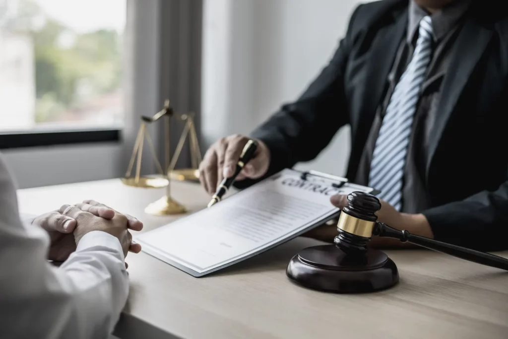 Attorney gives the client a pen to sign a contract admitting fraud, lawyer admits a fraud case in which client is a victim and will sue defendant who is a commercial partner. Fraud litigation concept.